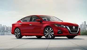 2023 Nissan Altima in red with city in background illustrating last year's 2022 model in Empire Nissan of Bay Ridge in Brooklyn NY