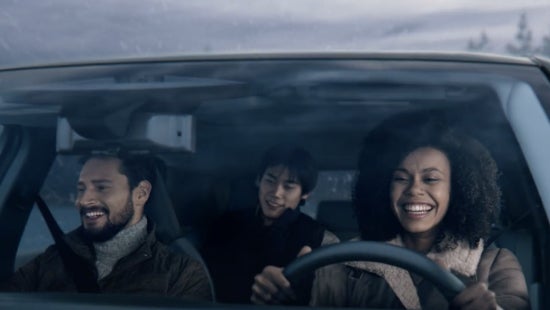 Three passengers riding in a vehicle and smiling | Empire Nissan of Bay Ridge in Brooklyn NY